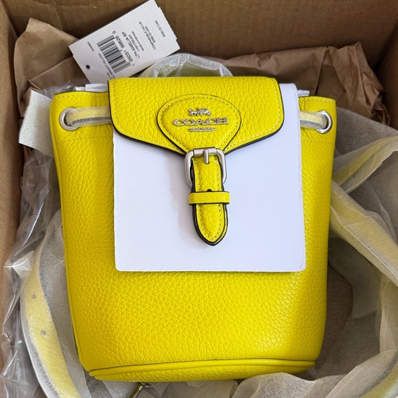 Coach Handbags - COACH  Amelia Yellow and White Pebbled Leather Mini Bucket Crossbody